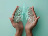 Hands holding a glass lung to evoke image of lung cancer