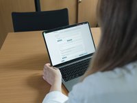 Doctor using the Template Designer on her laptop