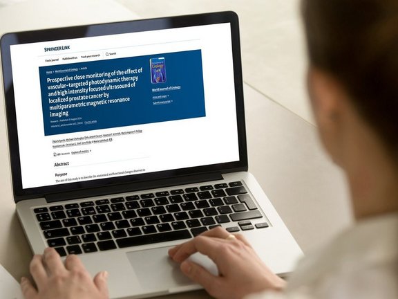 Woman reading the article on multiparametric MRI in prostate cancer treatments on her laptop