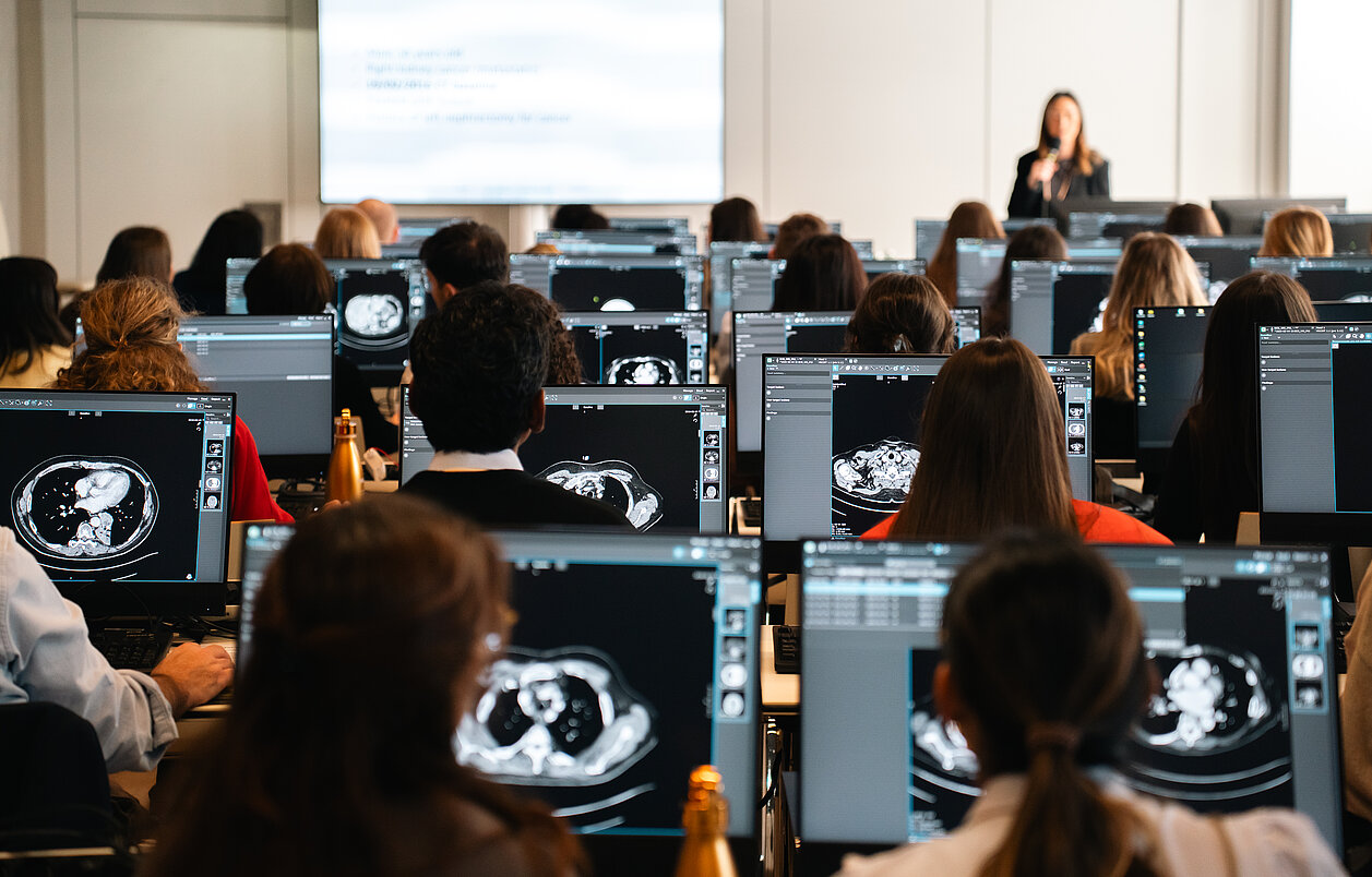 Radiologists working at workstations analyzing real CT images during an interactive RECIST workshop at ECR 2026