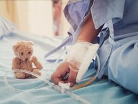 Pediatric cancer patient on a hospital bed receiving treatment